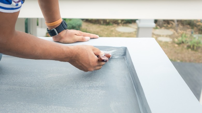 Man applying deck paint 