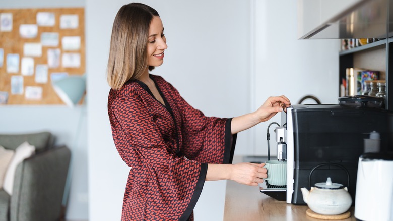 woman using coffee maker