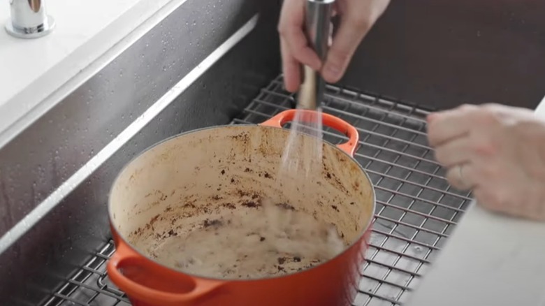 Spraying down stained enameled dutch oven