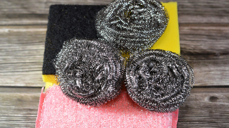 Abrasive sponge and scouring pads on a countertop