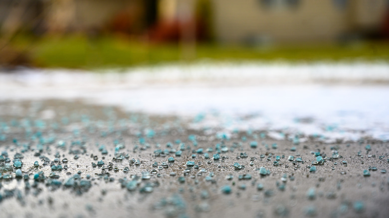 Rock salt on a concrete surface with snow