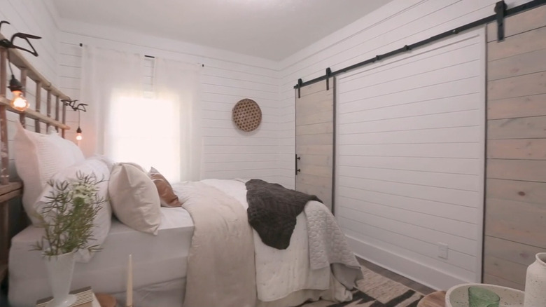 A modern farmhouse bedroom with barn doors