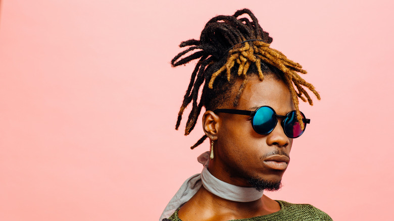 Man in front of pink background