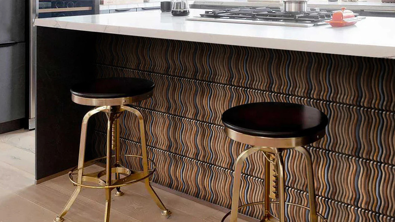 Wavy pattern wood paneling installed on the side of a kitchen island