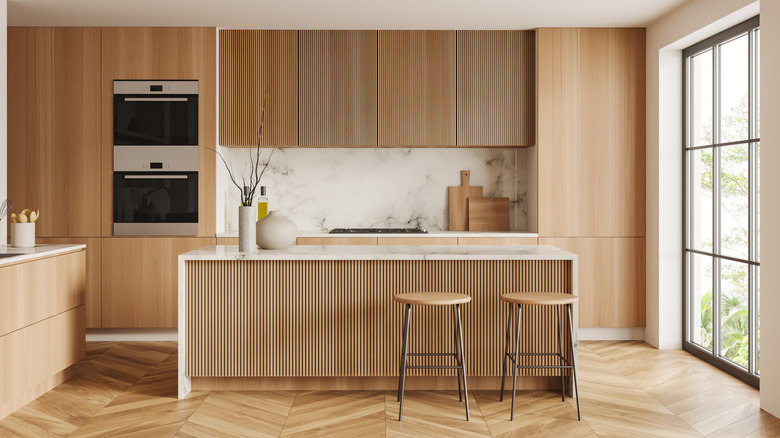 Modern wood-paneled kitchen with natural light wood cabinets