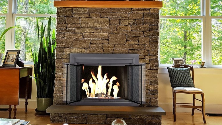 old rock fireplace with gray modern doors