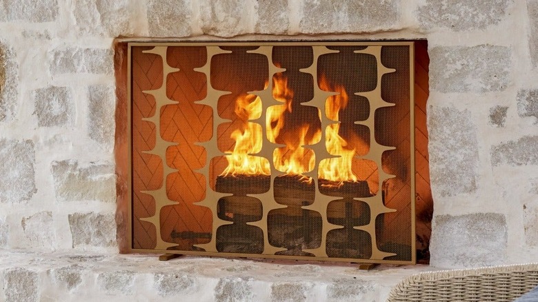 laser cut metal fireplace screen with cabin scene