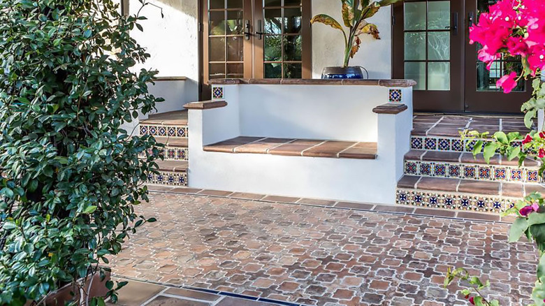 tiled patio with blooming plants