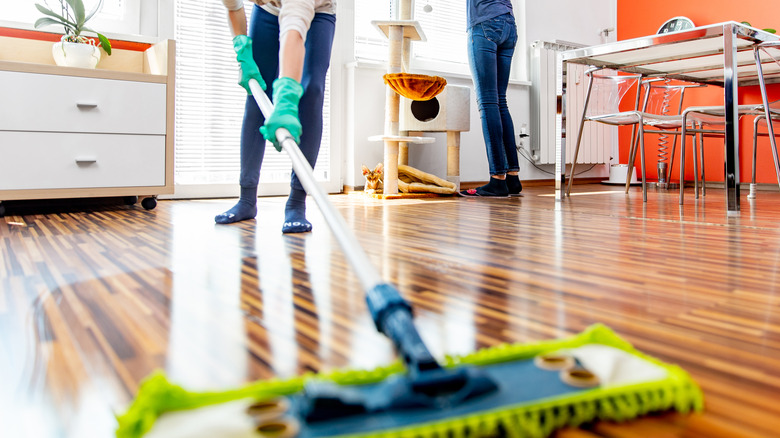 cleaning floor with damp mop