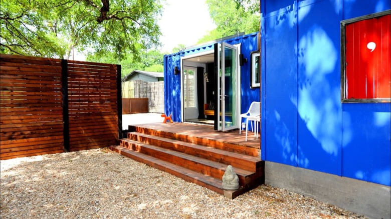 blue container house with steps