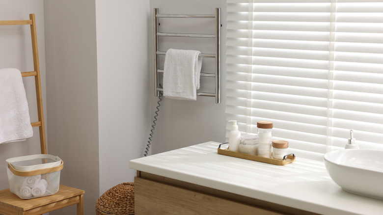 A heated towel rack in a bathroom