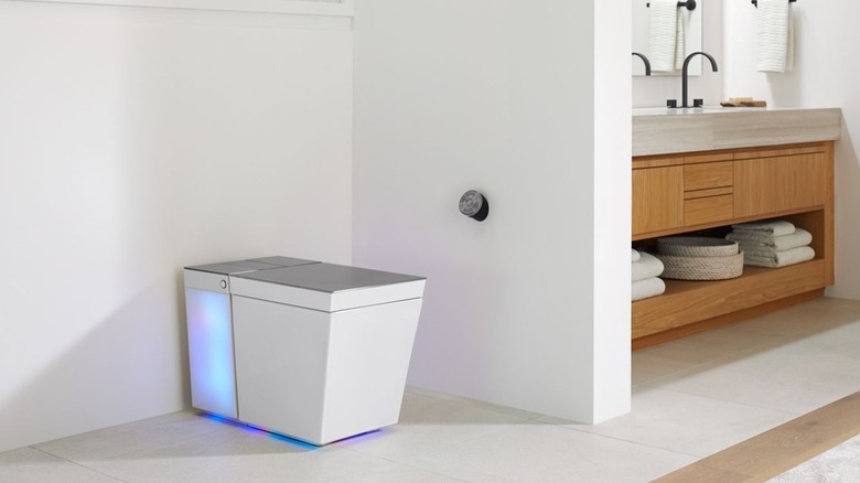 A bathroom with a smart toilet