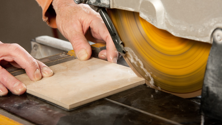 Wet saw cutting a tile