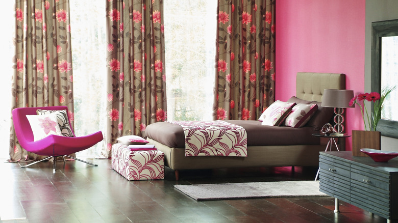 Bright pink bedroom with floral curtains