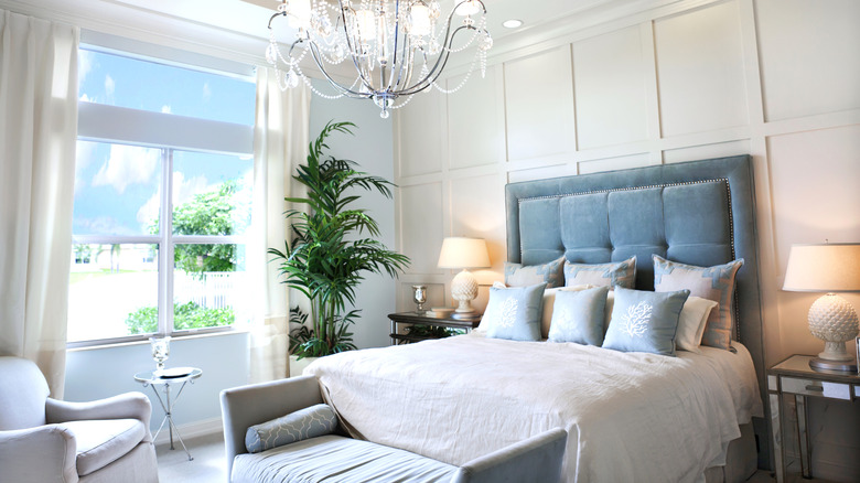 Bedroom with a chandellier and large window