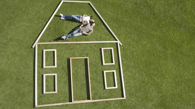 outline of wooden house on grass