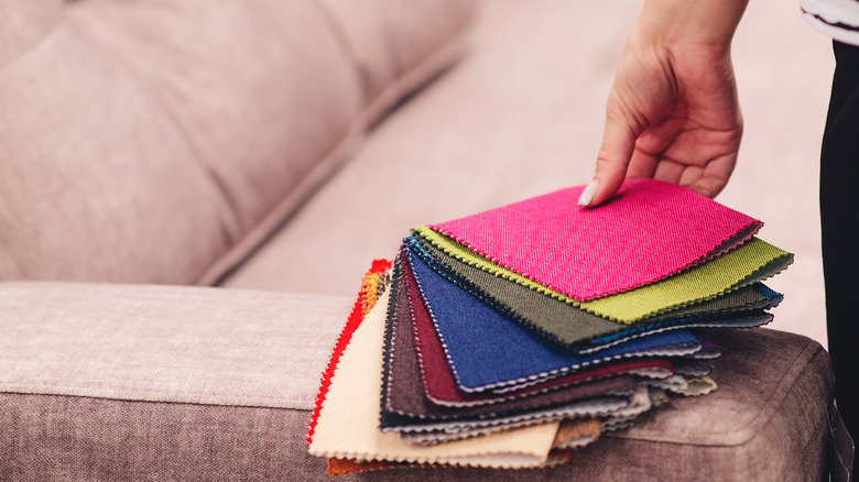 stack of fabric samples with hand