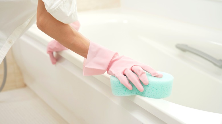 Woman cleaning bathrub