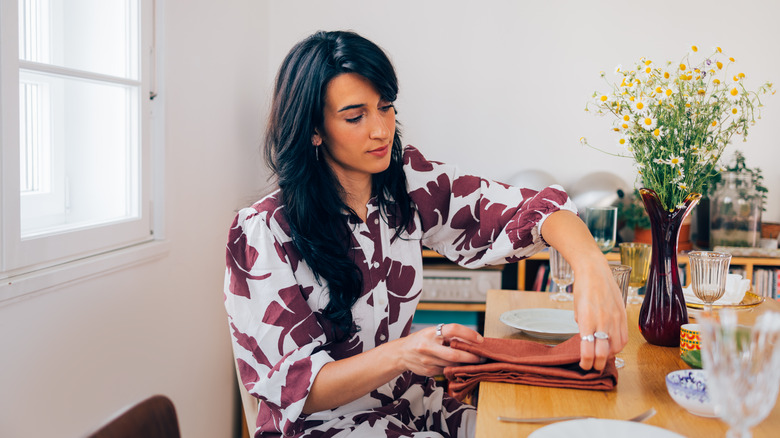 Person folding a dinner napkin