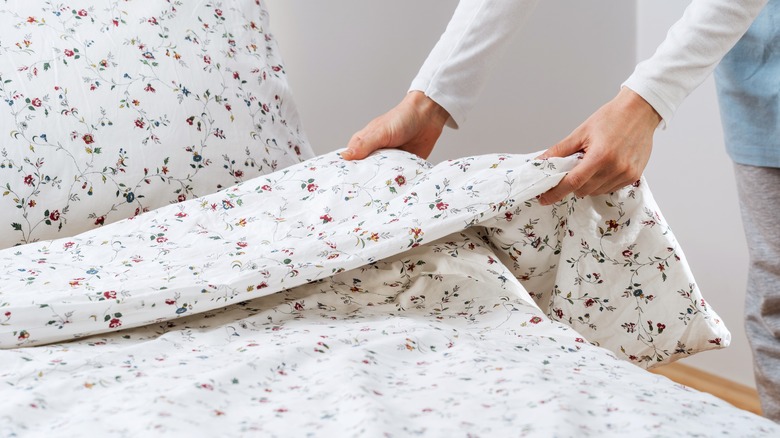 Woman fixing her duvet