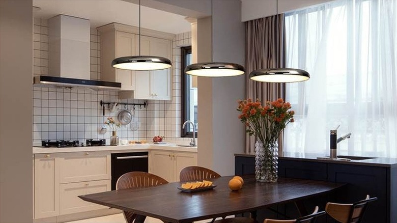 Saucer light fixtures styled above dining table