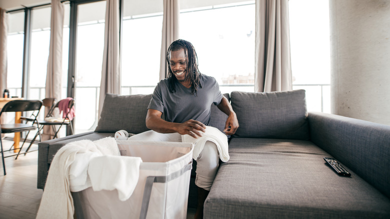 man folding sheets