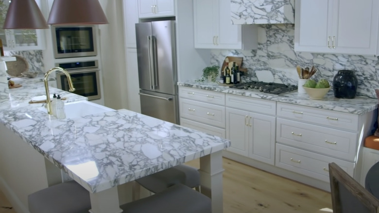 Modern kitchen with a marble peninsula countertop