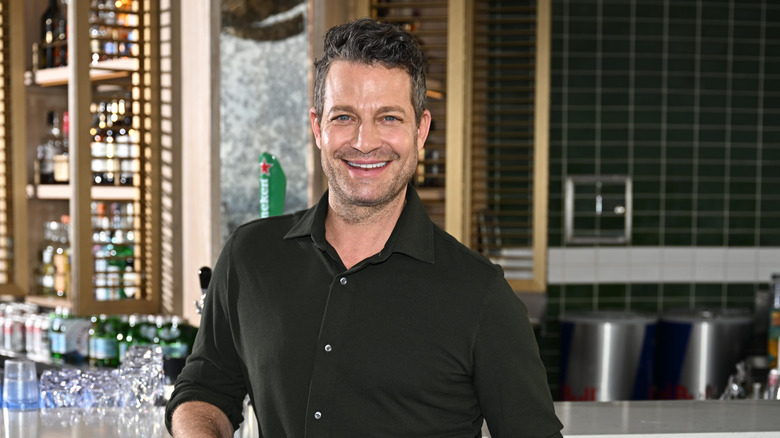 Nate Berkus smiling by bar