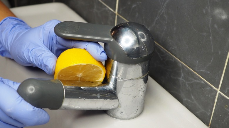 cleaning sink faucet with lemon