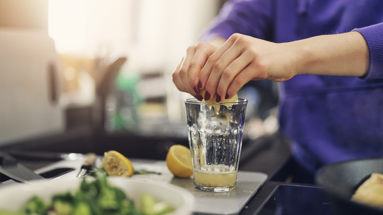 Woman squeezing lemon