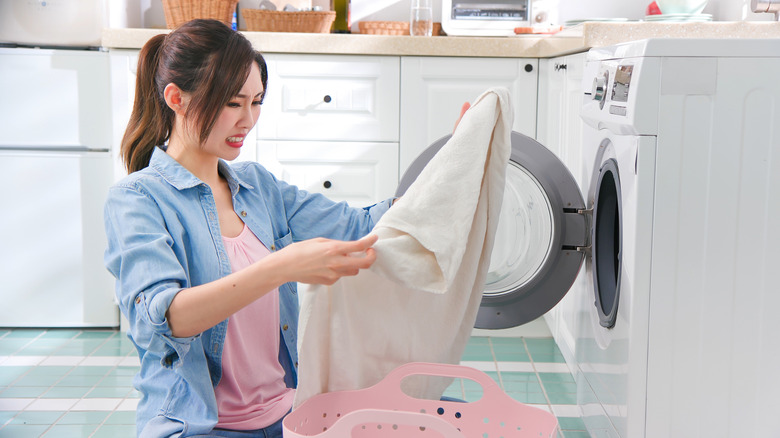 Woman smelling clothes