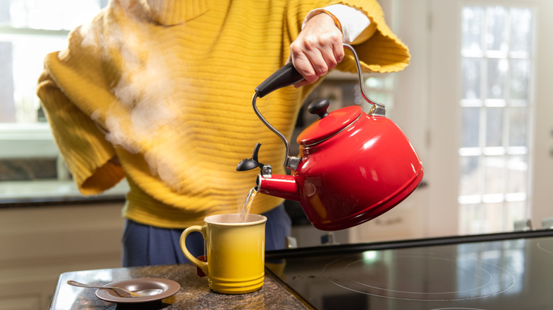 person pouring hot water