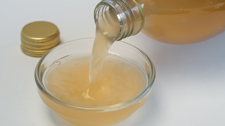 Pouring vinegar in bowl