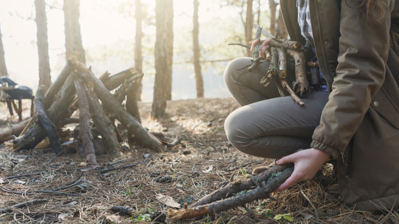 woman preparing campfire