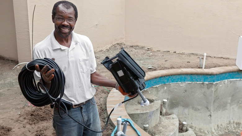 Man installing natural pool