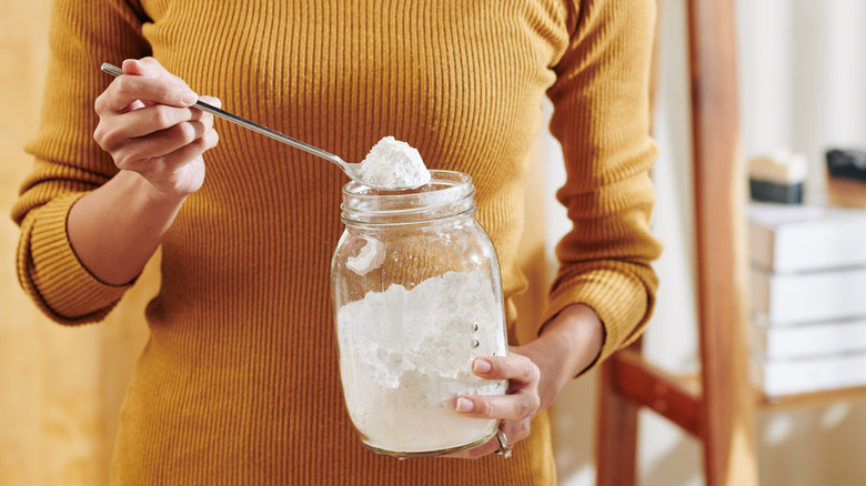 woman holding baking soda jar