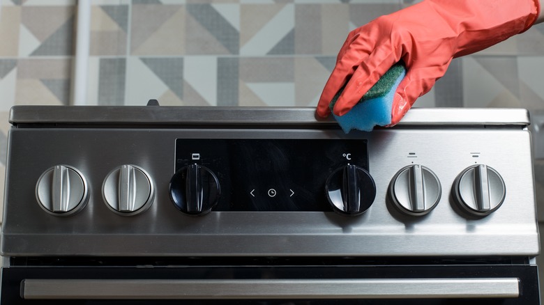 cleaning an oven with sponge