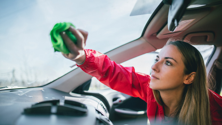 woman wiping car windshield