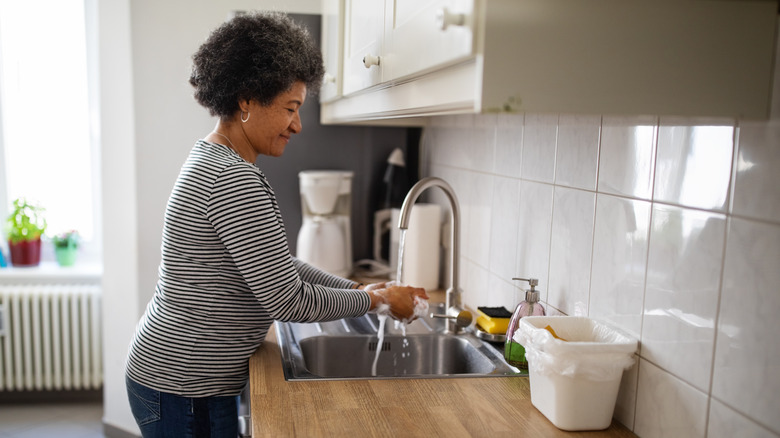 Someone washing hands in sink