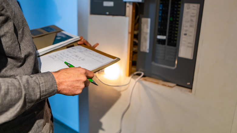 home inspector inspecting electric panel