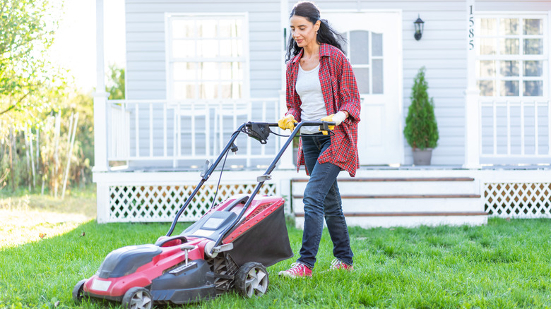 Woman mowing lawn