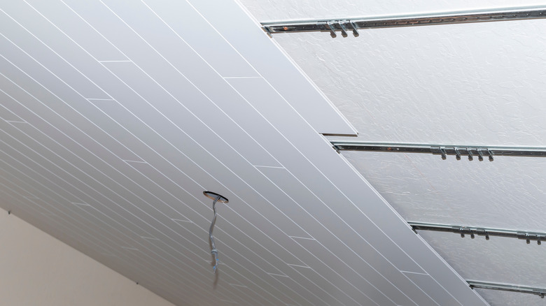 Nickel gap planks being installed on a ceiling