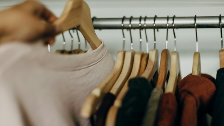 hand grabbing shirt on hanger