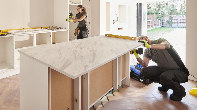 man installing countertop