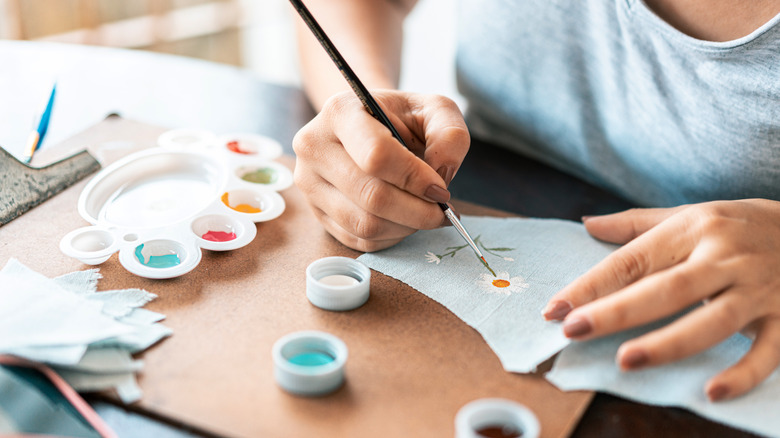 hands painting a fabric swatch