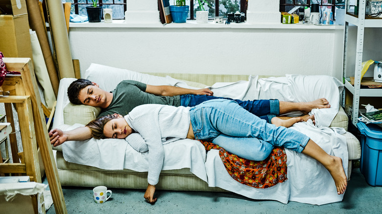 couple sleeping on uncomfortable couch