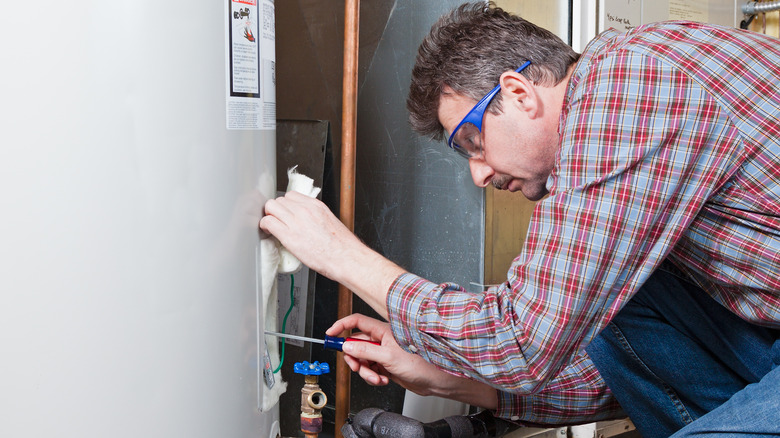 Man fixing water heater