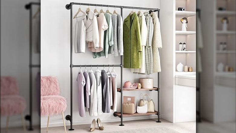 Bedroom featuring industrial pipes used as open closet