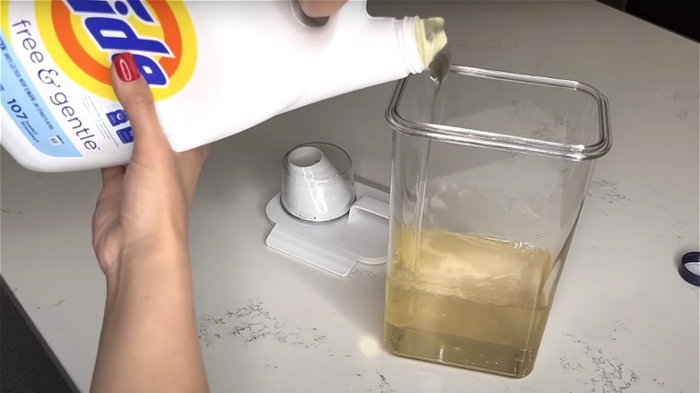 pouring detergent on transparent container