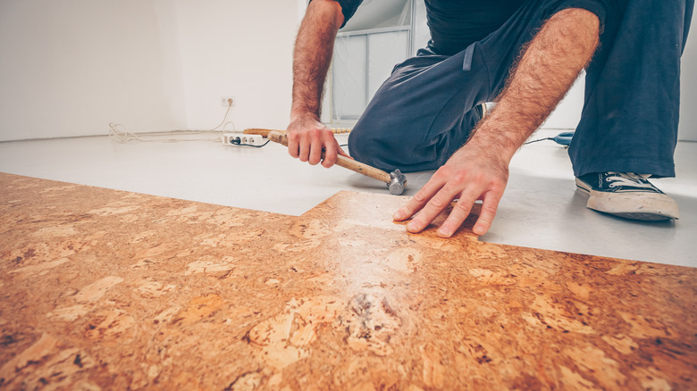 Man installs cork flooring